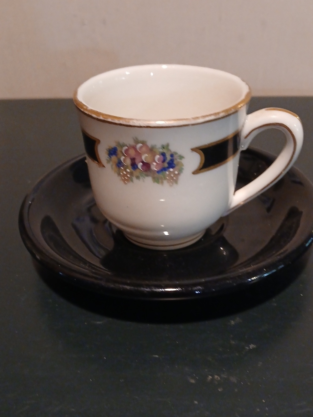 White Porcelain Tea Cup with Floral Accent and Gold Trim